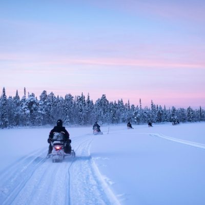 snowmobilingonthefrozenlakeatsunsetattorassieppilapland